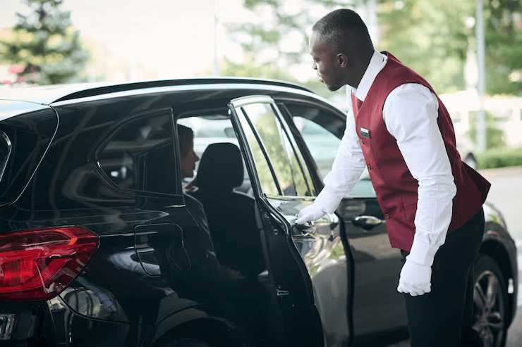 AA Limousine and Sedan chauffeur opening car door for client in Rockville