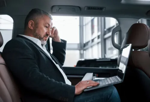 Corporate client relaxing in a premium sedan in Downtown DC