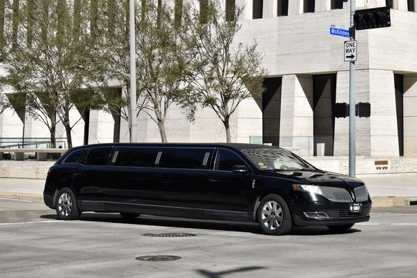 Professional chauffeur opening limo door in Greenbelt Maryland