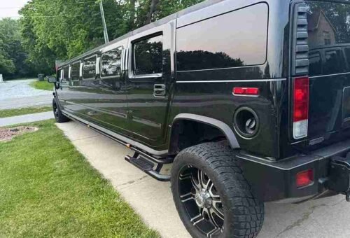 Professional chauffeur opening limo door for client in Montgomery County